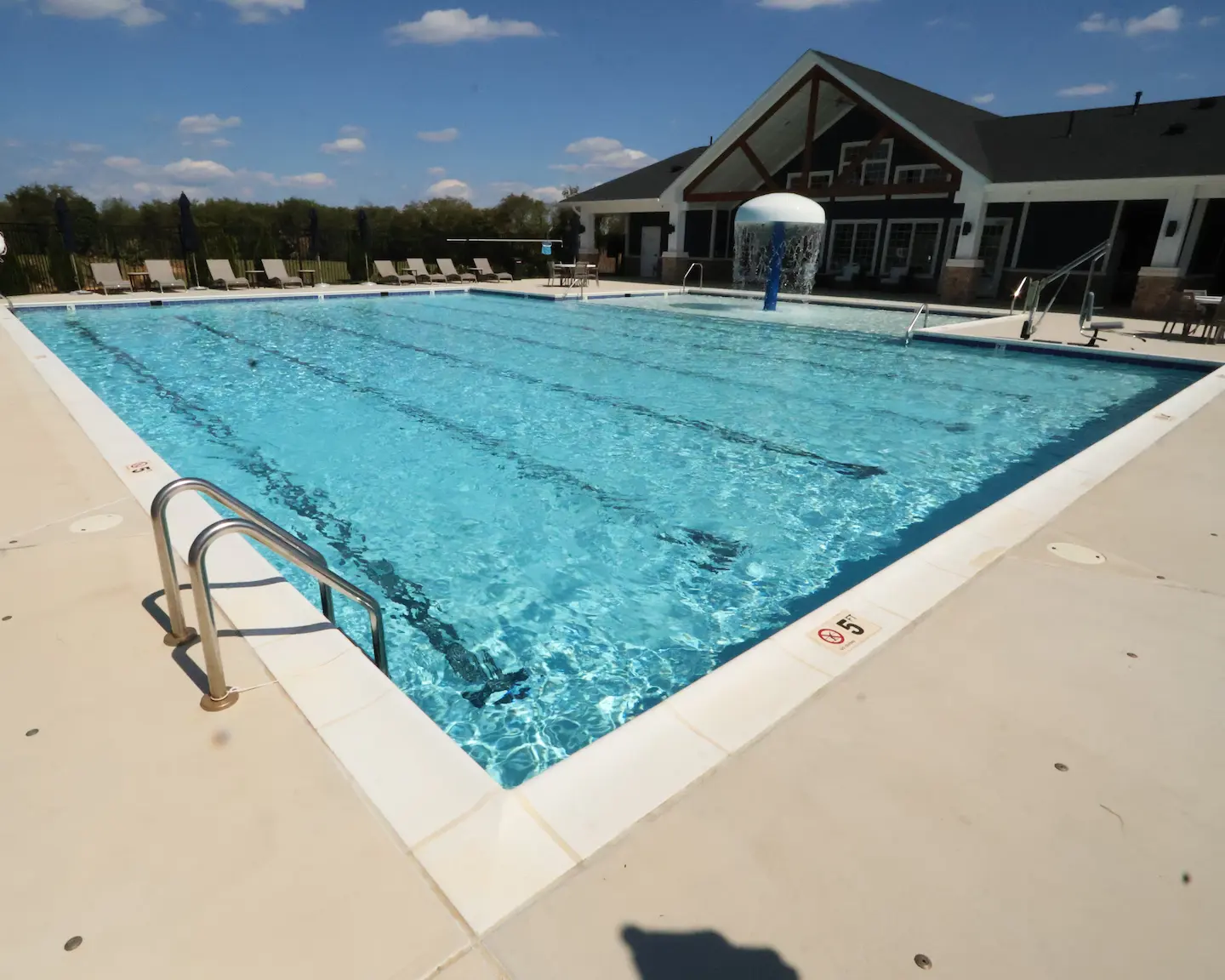 Outdoor pool surrounded by landscaping